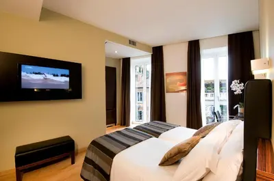 a bedroom with a bed and a tv on the wall at Trevi Collection Hotel - Gruppo Trevi Hotels in Rome