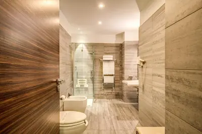 a bathroom with a toilet and a shower at Trevi Collection Hotel - Gruppo Trevi Hotels in Rome