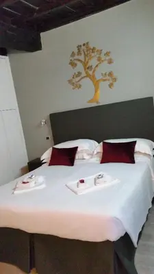 a bedroom with a large bed with towels on it at Navona First Rooms in Rome