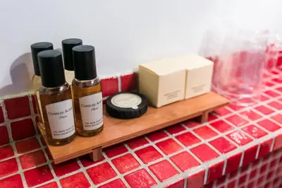 three bottles of essential oils sitting on a wooden shelf at Navona First Rooms in Rome