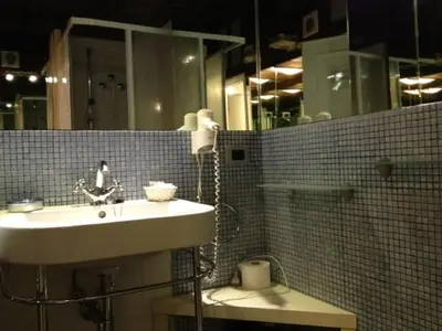 a bathroom with a sink and a toilet and a mirror at Navona First Rooms in Rome