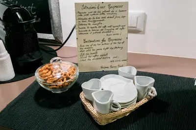 a basket of dishes and a sign on a table at Navona First Rooms in Rome