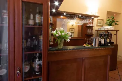 a bar with a vase of flowers on a counter at Hosianum Palace in Rome