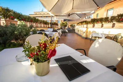 a white table with a vase of flowers on it at Hosianum Palace in Rome