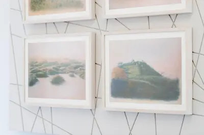 a group of framed photographs hanging on a wall at HT Romeo Al Babuino in Rome