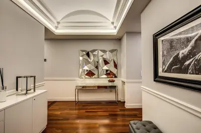 a room with a painting on the wall and a table at La Foresteria Luxury Suites in Rome