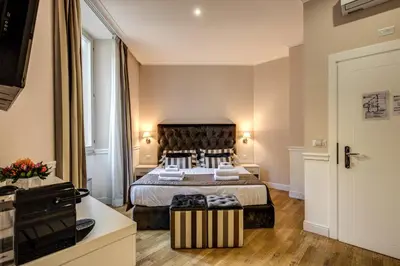 a bedroom with a bed and a large window at La Foresteria Luxury Suites in Rome