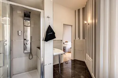 a bathroom with a sink and a shower at La Foresteria Luxury Suites in Rome