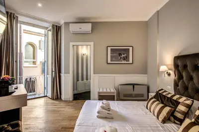 a bedroom with a bed and a living room at La Foresteria Luxury Suites in Rome