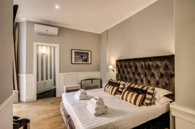 a bedroom with a large bed with towels on it at La Foresteria Luxury Suites in Rome