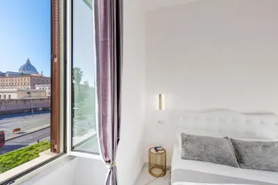 a bedroom with a bed and a flat screen tv at St. Peter Grand Suite in Rome