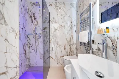 a white bedroom with a bed and a window at St. Peter Grand Suite in Rome