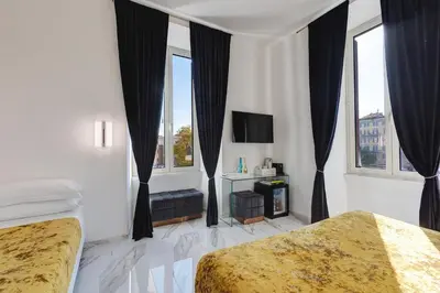 a white bedroom with a bed and a flat screen tv at St. Peter Grand Suite in Rome