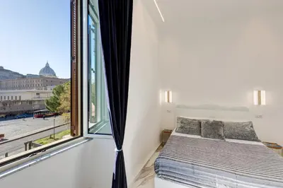 a bedroom with a bed and a large window at St. Peter Grand Suite in Rome