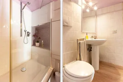 a bathroom with a toilet and a sink and a shower at Colosseum romantic loft in Rome