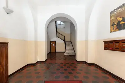 a hallway with a staircase in a building at Colosseum romantic loft in Rome