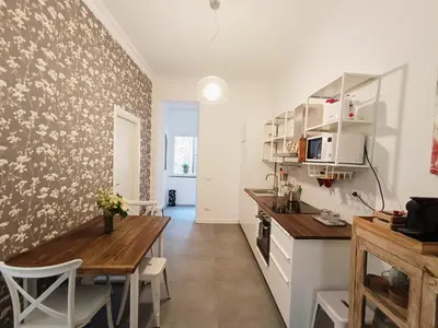 a kitchen with a table and a dining room at La tua casa a Piazza del Popolo in Rome