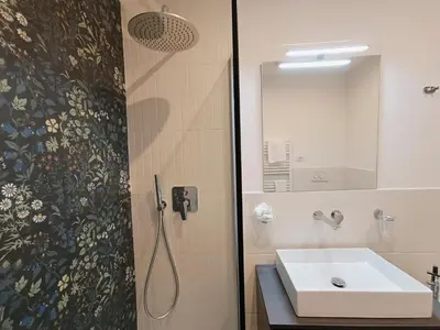 a bathroom with a sink and a shower with a mirror at La tua casa a Piazza del Popolo in Rome