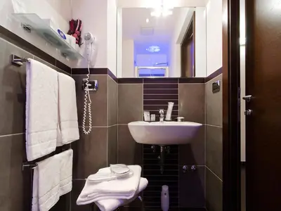 a small bathroom with a sink and a mirror at Cenci Bed & Breakfast Fontana di Trevi in Rome