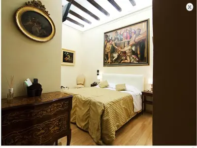 a bedroom with a bed and a painting on the wall at Cenci Bed & Breakfast Fontana di Trevi in Rome