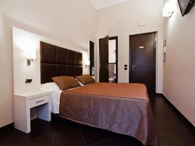 a bedroom with a large bed and a desk at Cenci Bed & Breakfast Fontana di Trevi in Rome