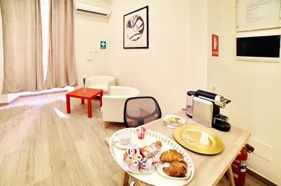 a living room with a table with food on it at Coladir Guest House in Rome