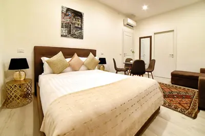 a bedroom with a large bed and a table at Coladir Guest House in Rome