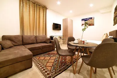 a living room with a couch and a table at Coladir Guest House in Rome
