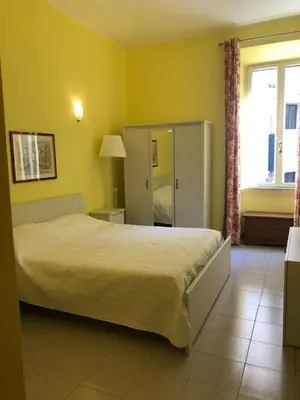 a bedroom with a large bed in a yellow room at Casa vacanze 