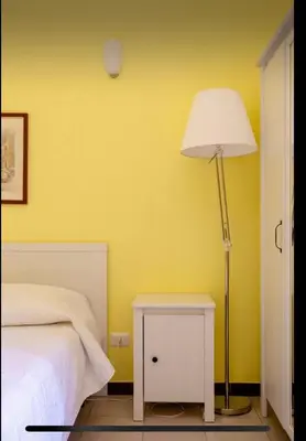 a yellow bedroom with a bed and a lamp at Casa vacanze 