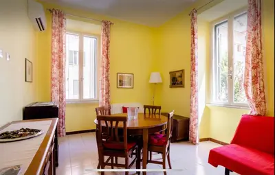 a dining room with a table and a red couch at Casa vacanze 