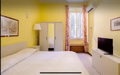 a bedroom with a large bed and a television at Casa vacanze 