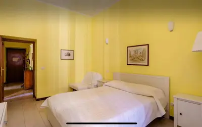 a bedroom with a bed and a chair in it at Casa vacanze 