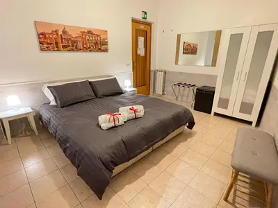 a bedroom with a bed with two pillows on it at Roman Holidays Rooms Otranto in Rome