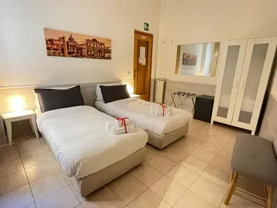 a living room with two beds and a couch at Roman Holidays Rooms Otranto in Rome