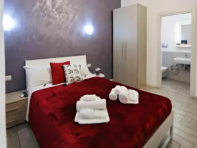 a bedroom with a large bed with towels on it at Relais Villa Borghese in Rome