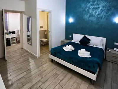 a bedroom with a bed with towels on it at Relais Villa Borghese in Rome