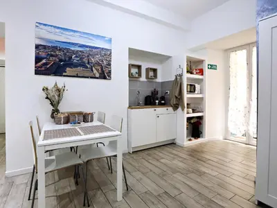 a kitchen and dining room with a white table and chairs at Relais Villa Borghese in Rome