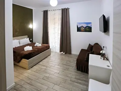 a bedroom with a bed and a couch at Relais Villa Borghese in Rome