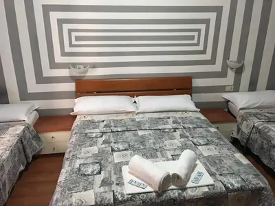 a room with two beds with towels on them at Hi Termini in Rome