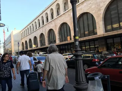 a group of people walking down a city street at Hi Termini in Rome