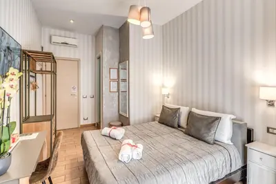 a bedroom with a bed with two towels on it at Marta Inn in Rome