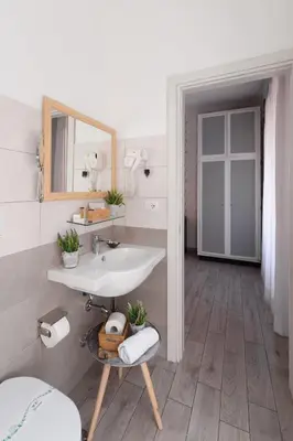 a bathroom with a sink and a mirror at Marta Inn in Rome
