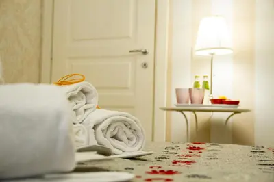 a pile of towels sitting on top of a table at Marta Inn in Rome