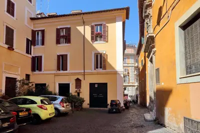 an alley with cars parked in front of a building at Pantheon Charming Attic | Romeloft in Rome