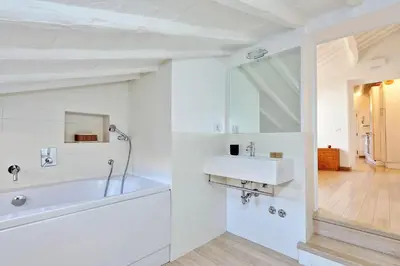 a white bathroom with a sink and a mirror at Pantheon Charming Attic | Romeloft in Rome