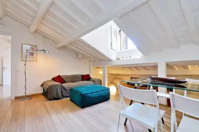 a living room with a table and a couch at Pantheon Charming Attic | Romeloft in Rome