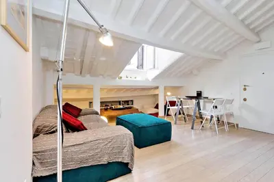 a bedroom with a bed and a dining room at Pantheon Charming Attic | Romeloft in Rome