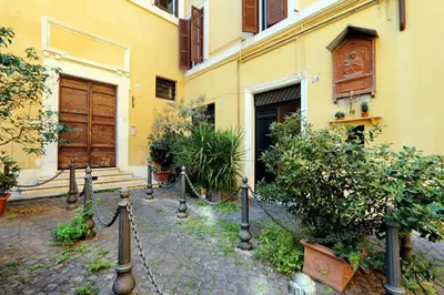 a building with a fence and plants in front of it at Pantheon Charming Attic | Romeloft in Rome