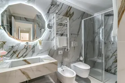 a white bathroom with a sink and a mirror at Rome55 - Piazza di Spagna in Rome